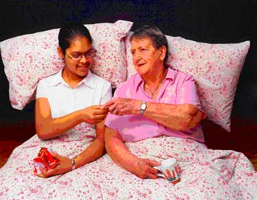 With the picture of two under a duvet with biscuits and tea