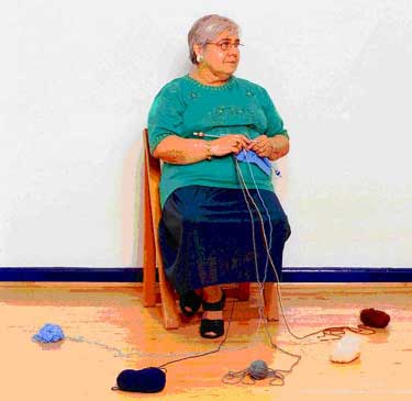 With the picture of woman knitting many balls of wool